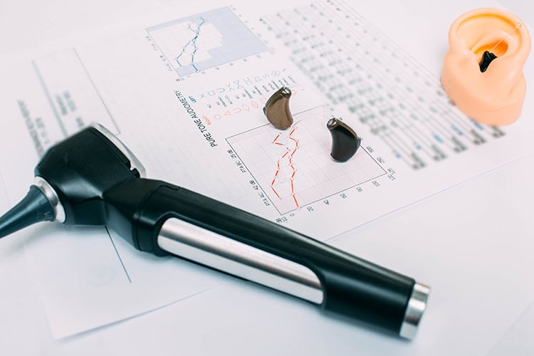 Hearing,Test,Concept.,Result,Of,Hearing,Exam,-,Audiogram,,Hearing Hearing test concept. Result of hearing exam - audiogram, hearing aids and otoscope on the table, view from above.