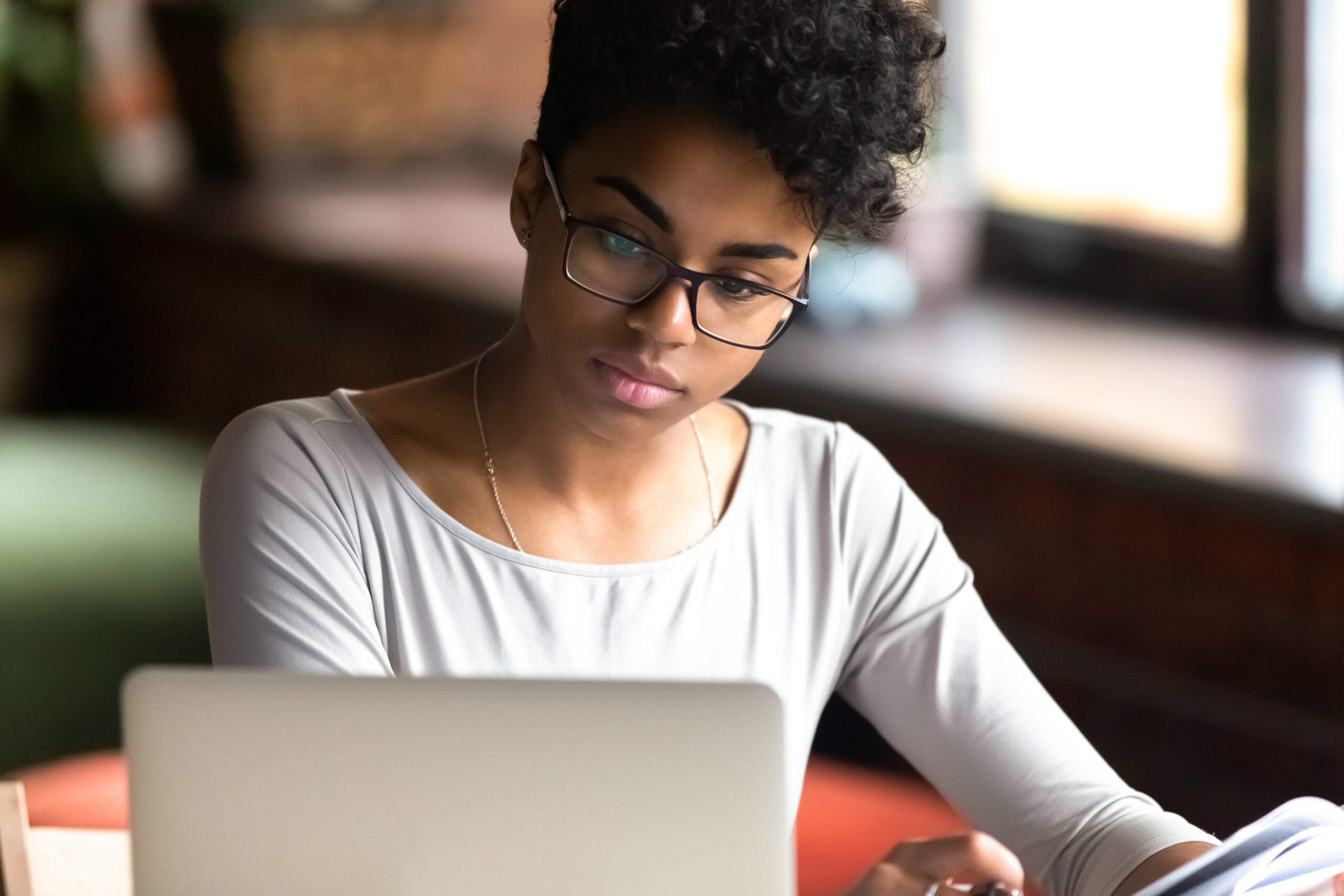 Thoughtful,Millennial,African,American,Woman,In,Glasses,Look,At,Laptop Doctoral Programs