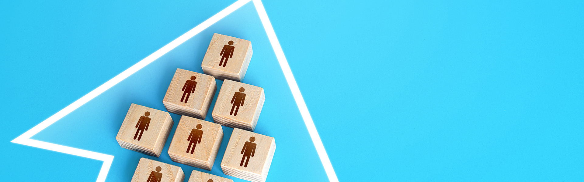 A group of people form a single movement arrow. / shutterstock.com