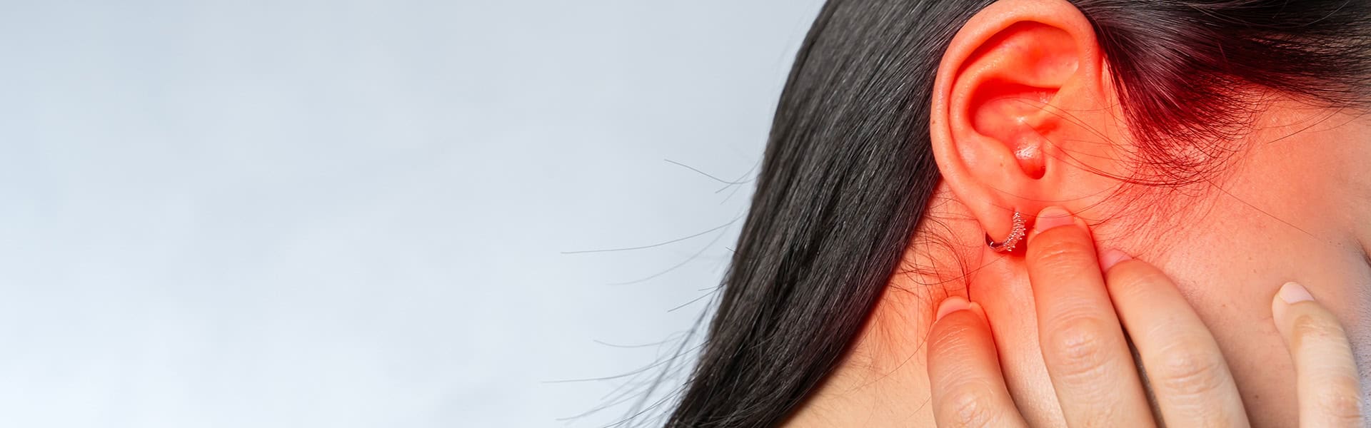 Image of Young woman suffering from ear pain and tinnitus / shutterstock.com